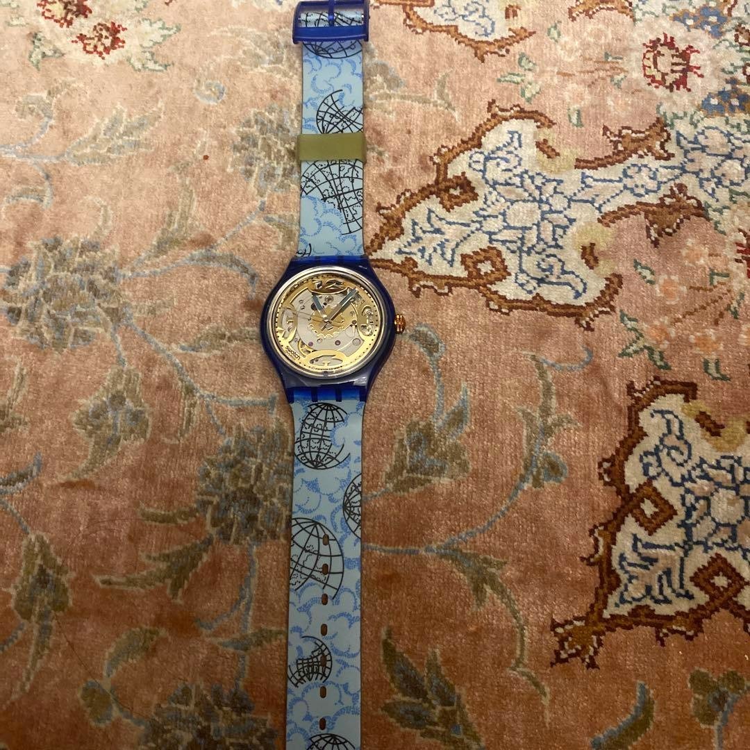 SWATCH Automatic Skeleton Watch Blue Clear Case World Map Strap Gold Dial New