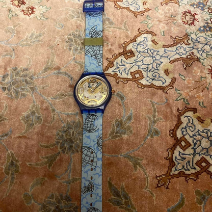 SWATCH Automatic Skeleton Watch Blue Clear Case World Map Strap Gold Dial New