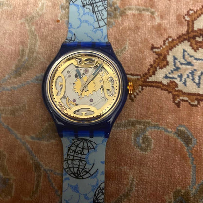 SWATCH Automatic Skeleton Watch Blue Clear Case World Map Strap Gold Dial New