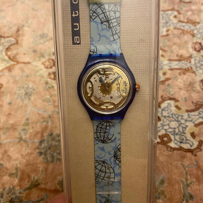 SWATCH Automatic Skeleton Watch Blue Clear Case World Map Strap Gold Dial New