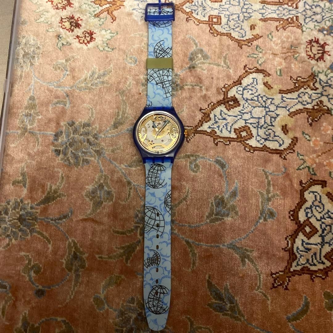 SWATCH Automatic Skeleton Watch Blue Clear Case World Map Strap Gold Dial New