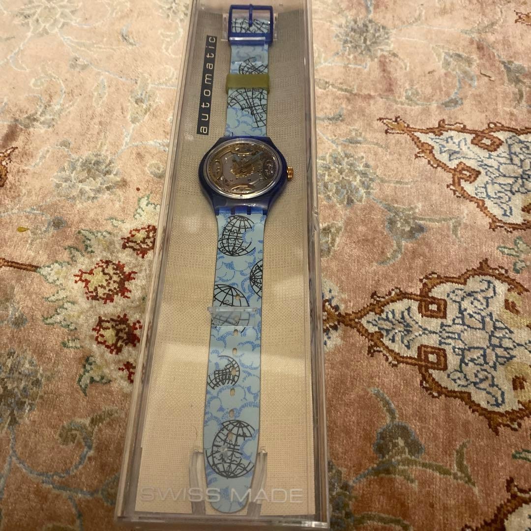 SWATCH Automatic Skeleton Watch Blue Clear Case World Map Strap Gold Dial New